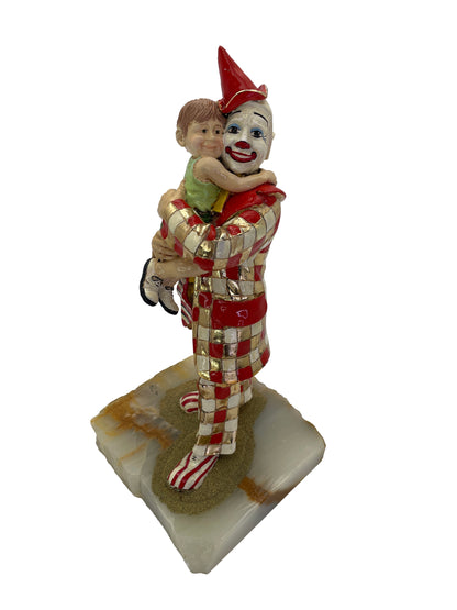 Vintage Ron Lee child embracing clown sculpture, signed and dated 1985, crafted with enamel and 24K gold-plated accents on a natural onyx base.