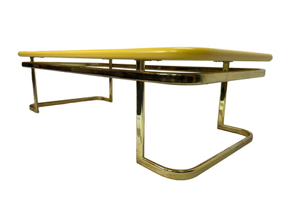 Opposite side angle view of vintage Lane coffee table featuring rounded yellow lacquer top and brass-tone legs.