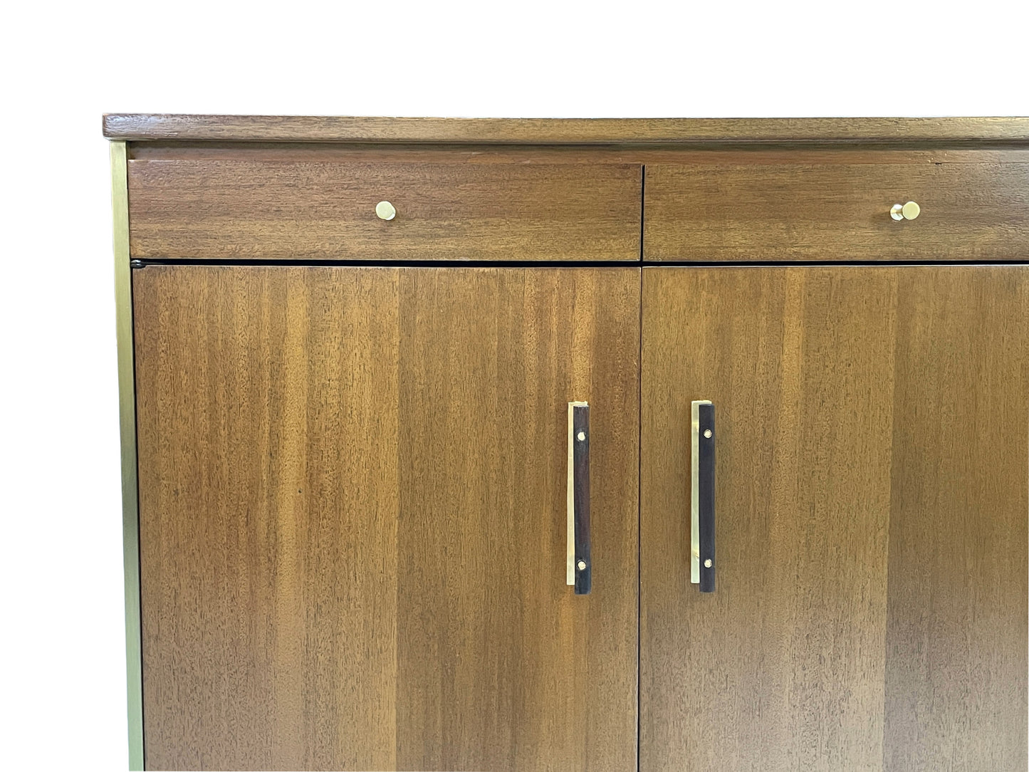 Detail view of brass cabinet pulls and ribbon mahogany wood grain on a Paul McCobb for Calvin Group credenza with restored finish and mid-century modern design.