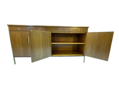 Interior view of a Paul McCobb for Calvin Group credenza showing spacious cabinet storage with adjustable shelves and restored ribbon mahogany interior.