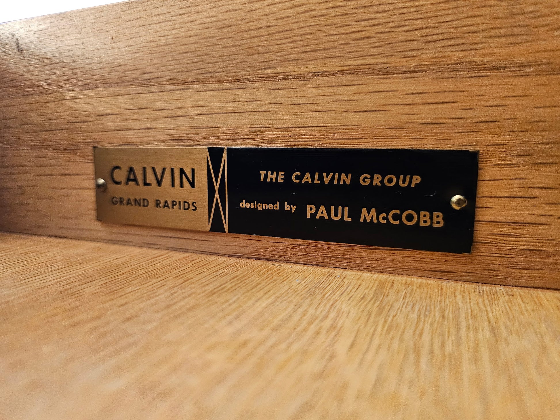 Original Calvin Group maker’s label identifying Paul McCobb as designer, mounted inside a restored ribbon mahogany credenza manufactured in Grand Rapids, Michigan.