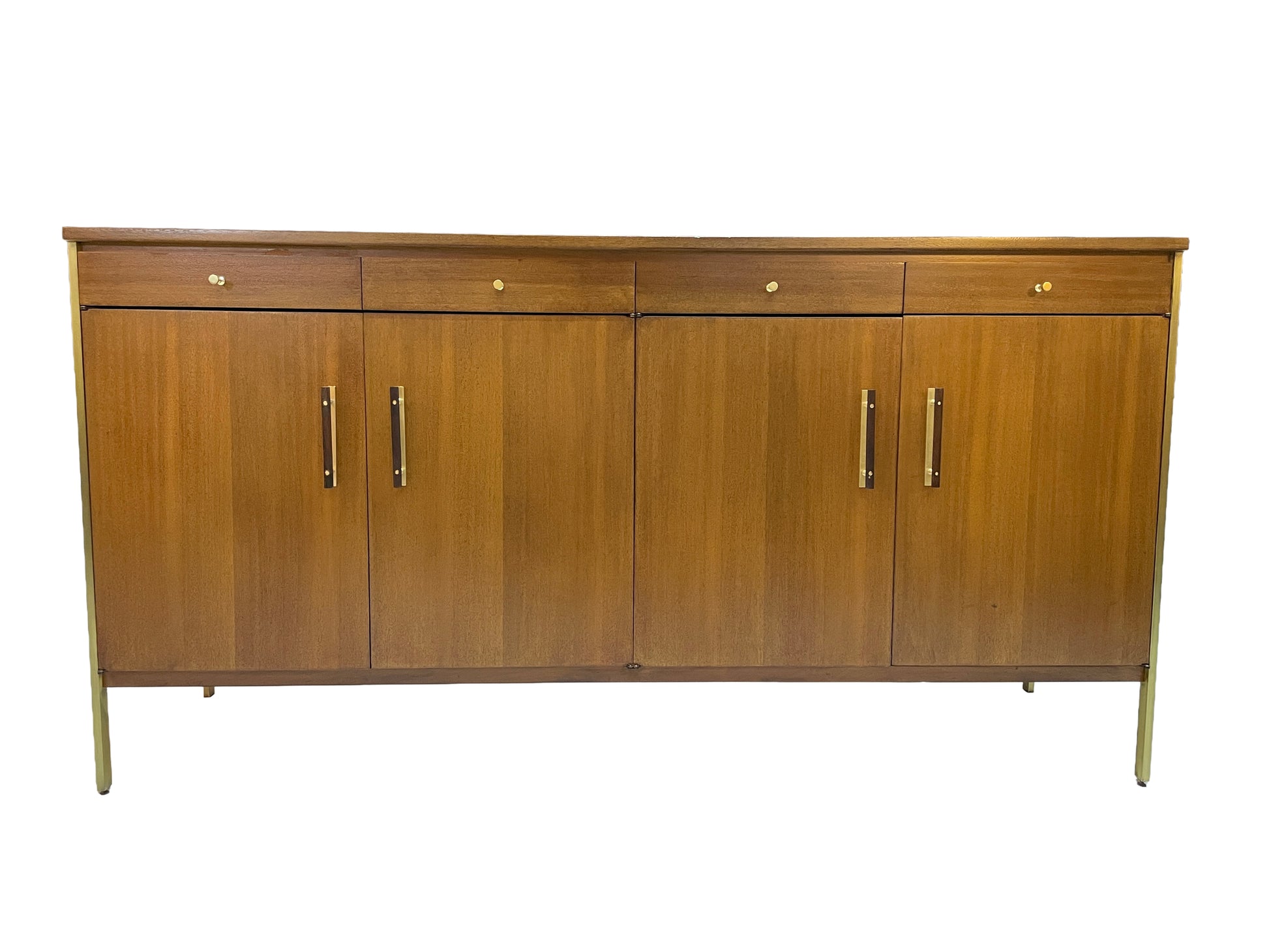 Front view of a restored Paul McCobb for Calvin Group ribbon mahogany credenza with four drawers, four cabinet doors, brass hardware, and brass post legs, circa 1960s.