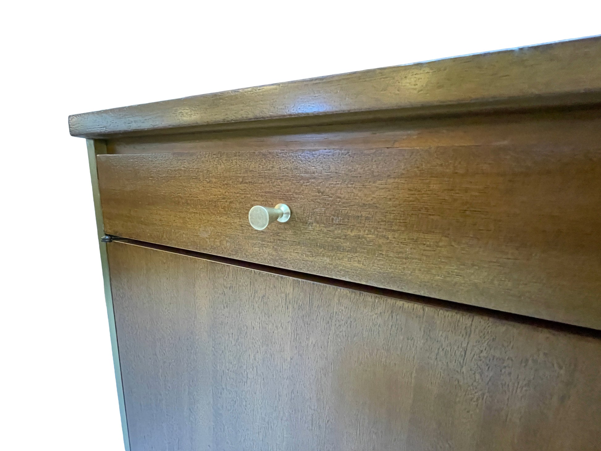 Close-up detail of original brass drawer pull on a restored Paul McCobb Calvin Group ribbon mahogany credenza, circa 1960s.