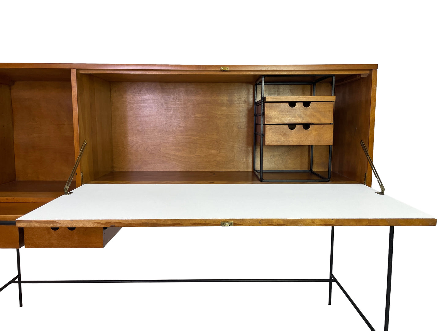 Interior detail of Paul McCobb Planner Group secretary desk with fold-down writing surface, maple storage compartments, and black metal organizer frame.