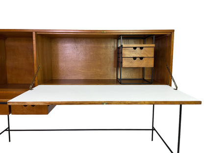 Interior detail of Paul McCobb Planner Group secretary desk with fold-down writing surface, maple storage compartments, and black metal organizer frame.