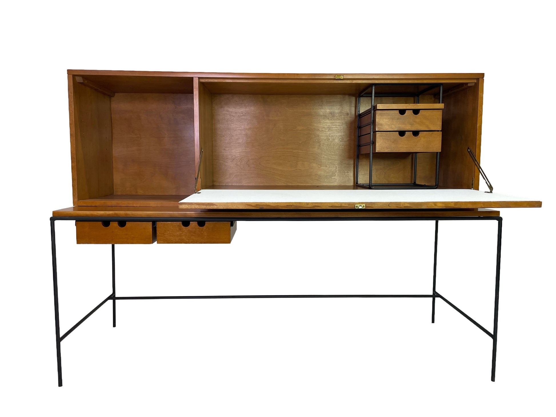 Paul McCobb Planner Group secretary desk for Winchendon Furniture featuring open drop-front writing surface, maple cabinet, black iron frame, and integrated storage drawers, circa 1950s.