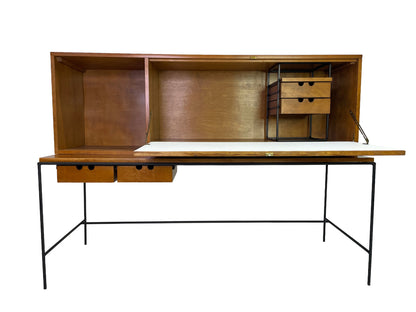 Paul McCobb Planner Group secretary desk for Winchendon Furniture featuring open drop-front writing surface, maple cabinet, black iron frame, and integrated storage drawers, circa 1950s.