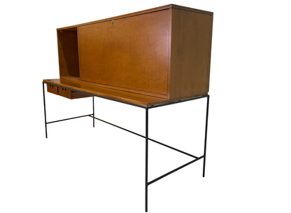 Rear angled view of Paul McCobb Planner Group secretary desk with maple storage cabinet, black iron frame, and clean mid-century modern lines.