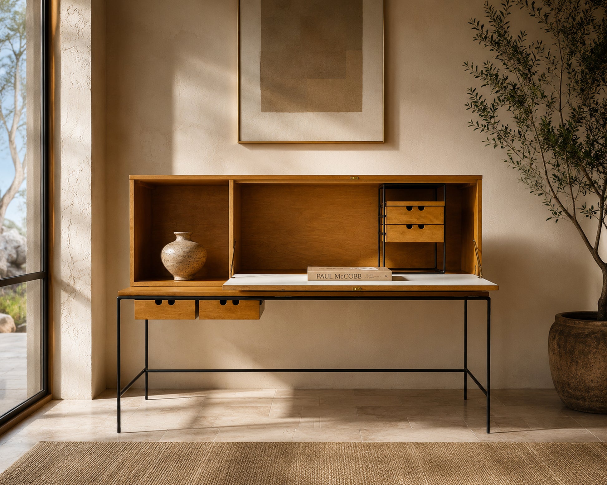 Paul McCobb Planner Group secretary desk for Winchendon Furniture in a warm California modernist interior featuring maple wood, black iron frame, and mid-century modern styling.
