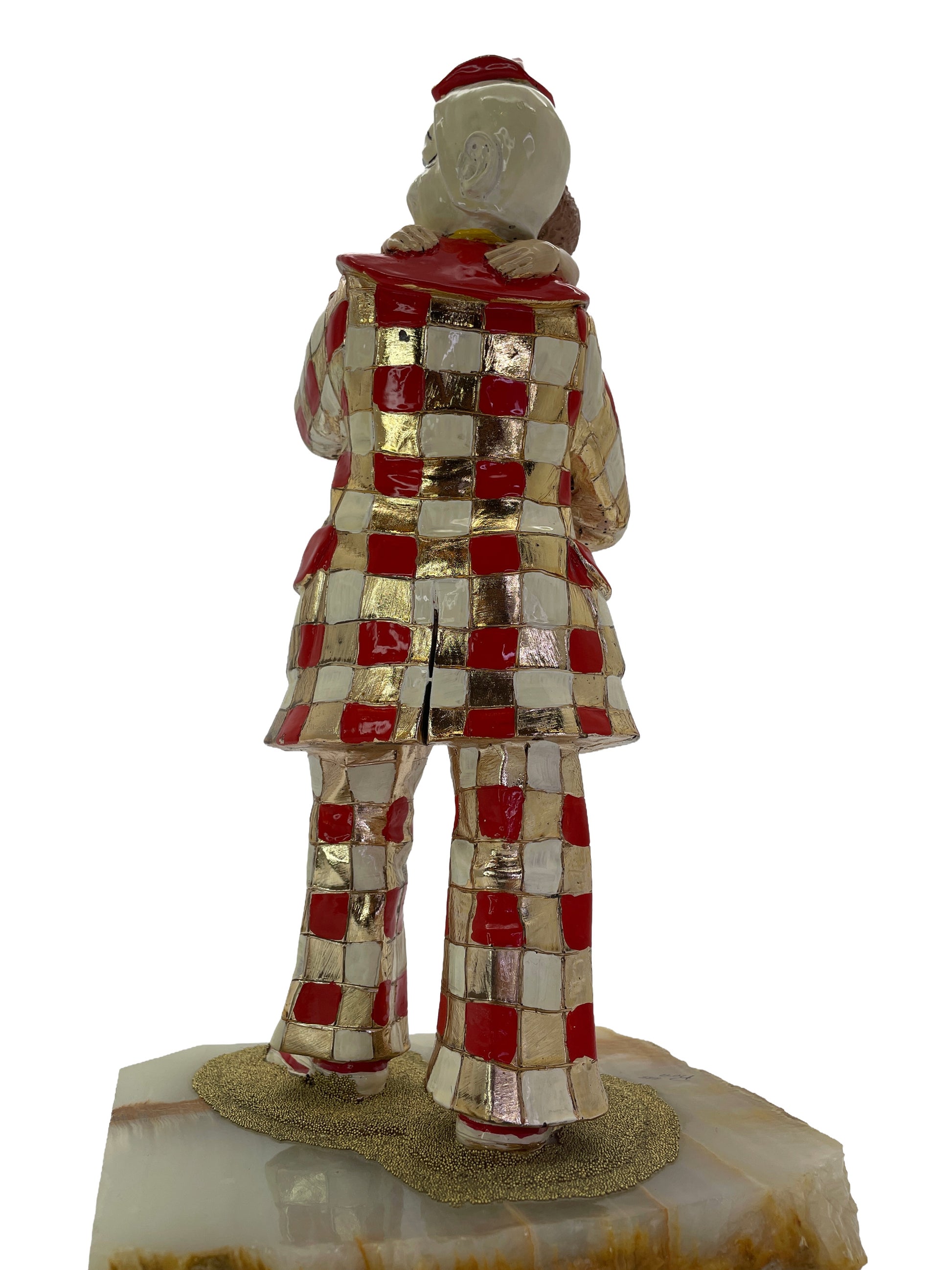 Rear detail of a signed 1985 Ron Lee sculpture showing the checkerboard costume and natural onyx base.