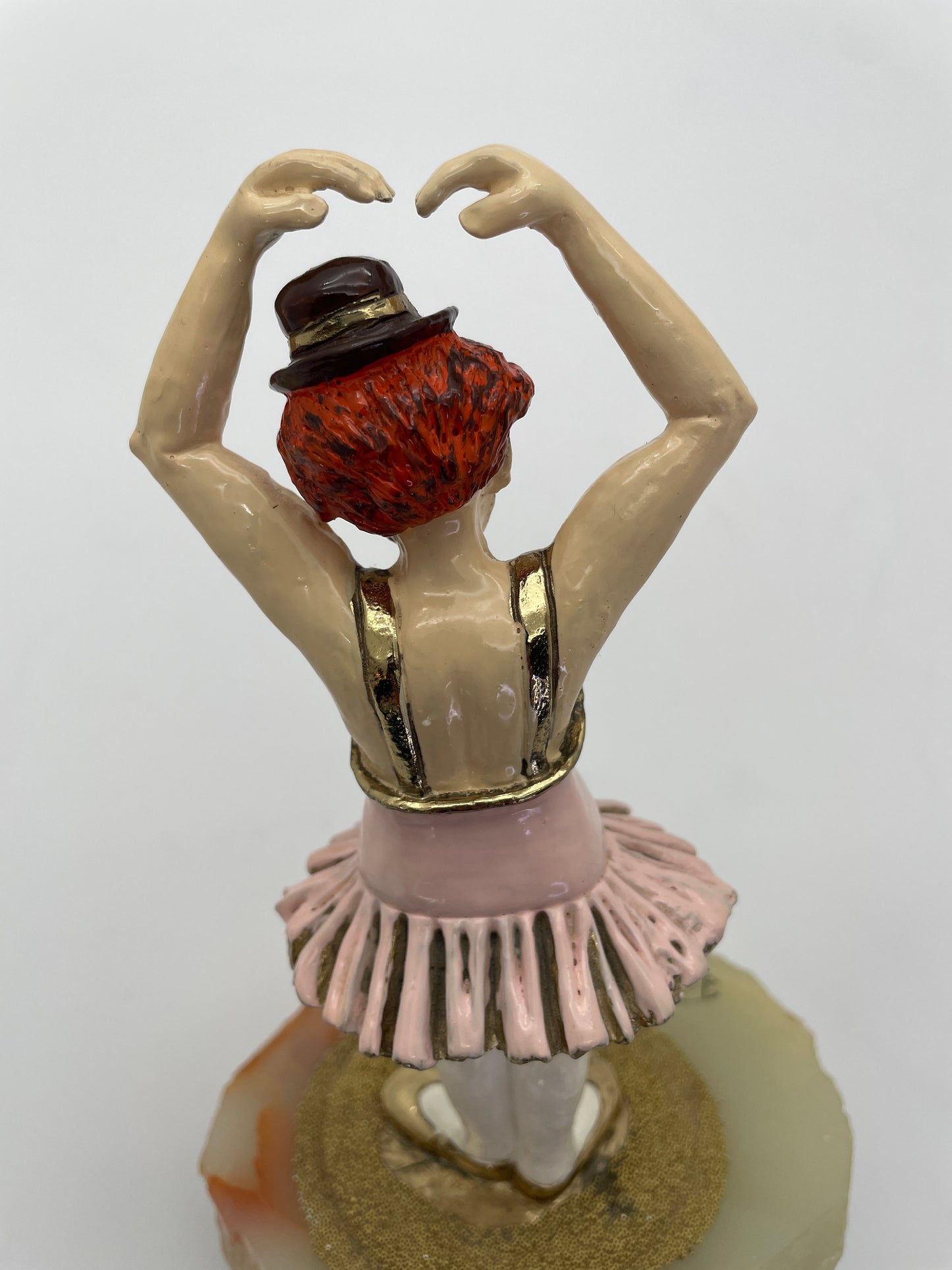 Rear detail of a vintage Ron Lee ballerina clown sculpture highlighting the pink tutu, gold-plated trim, and hand-painted finish.