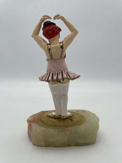 Rear view of a vintage Ron Lee ballerina clown sculpture with pink tutu, 24K gold-plated accents, and natural onyx base.
