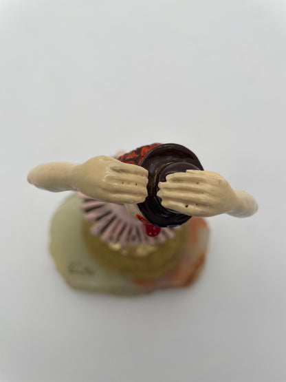 Top view of a vintage Ron Lee ballerina clown sculpture showing the raised ballet pose, bowler hat, and hand-painted details.