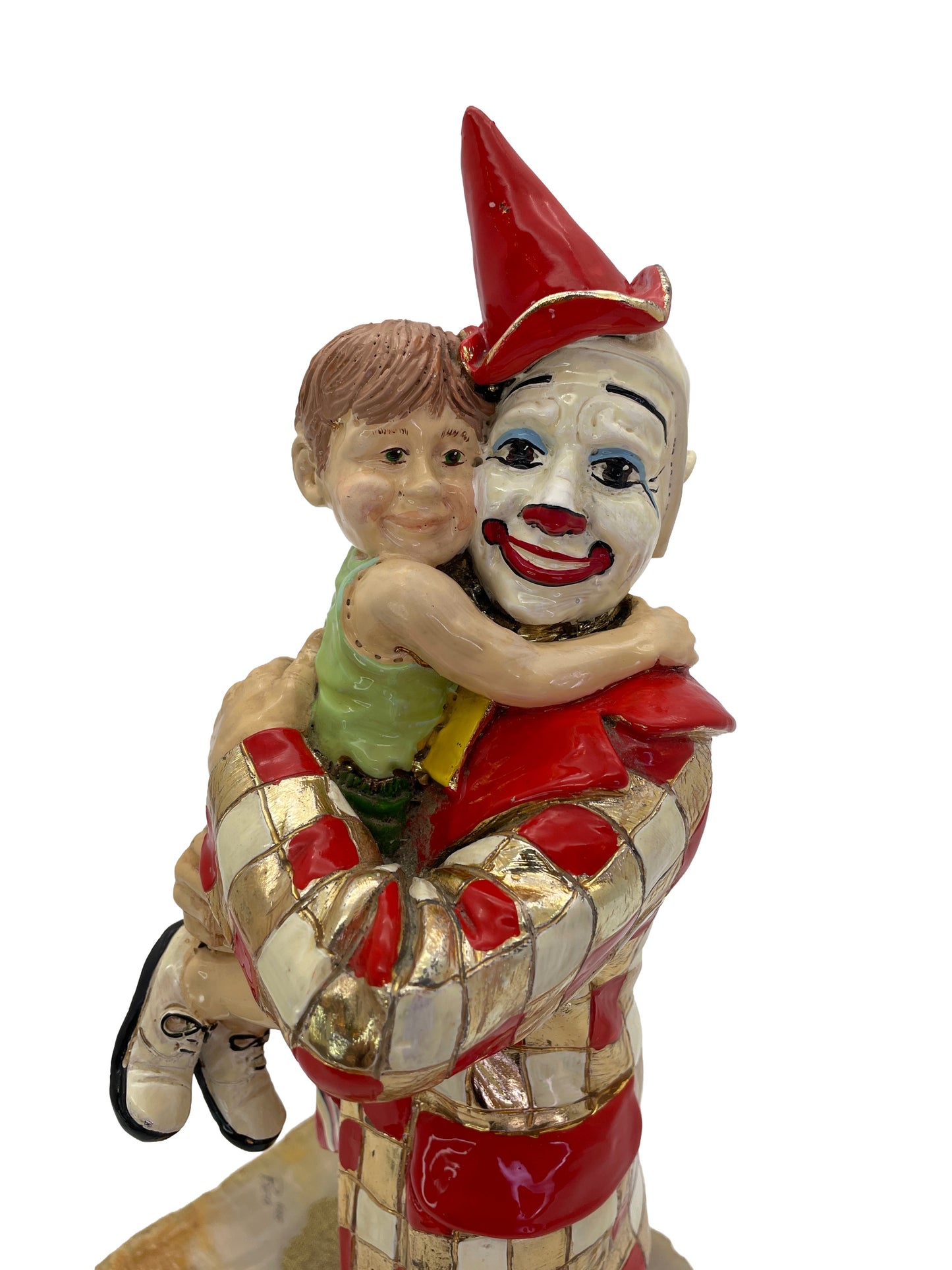 Close-up of the expressive faces on a signed Ron Lee sculpture depicting a child embracing a smiling clown.