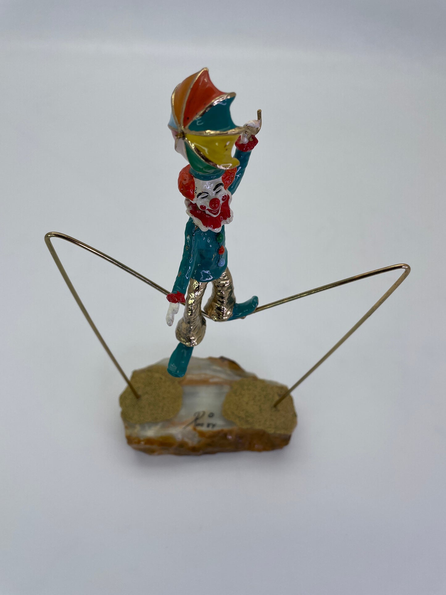 Elevated front angle showing the colorful umbrella and balancing pose of a Ron Lee clown sculpture.