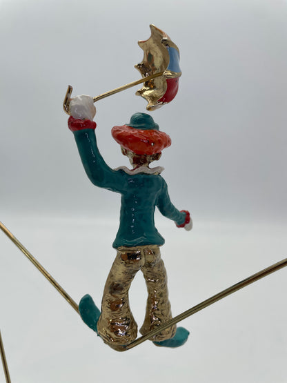 Rear close-up detail of the clown and umbrella on a Ron Lee tightrope sculpture.