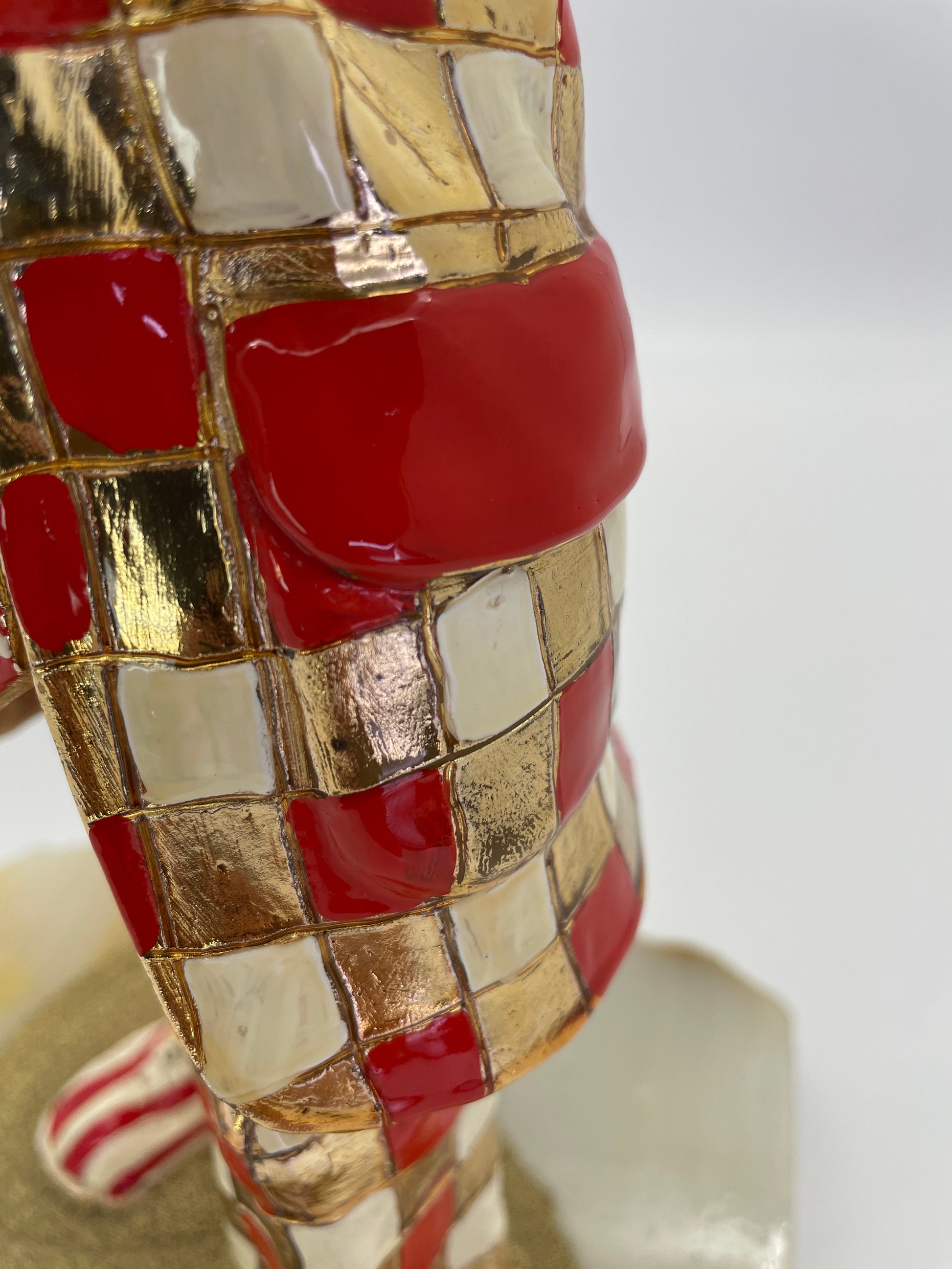 Close-up of the red, white, and 24K gold-plated checkerboard costume with hand-painted enamel on a vintage Ron Lee sculpture.