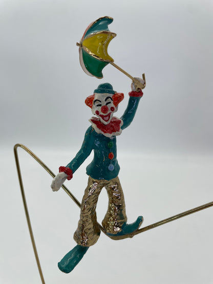 Close-up of the smiling clown face and colorful umbrella on a vintage Ron Lee sculpture.