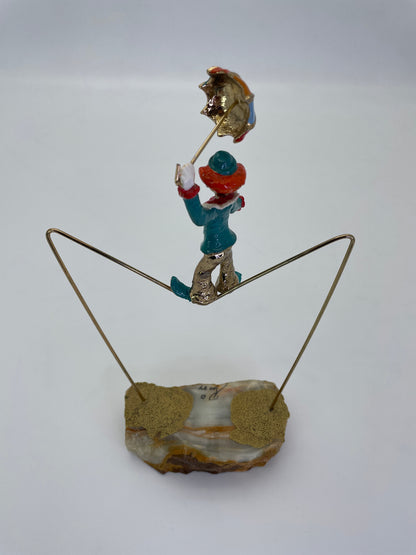 Rear three-quarter view of a Ron Lee circus tightrope clown sculpture.