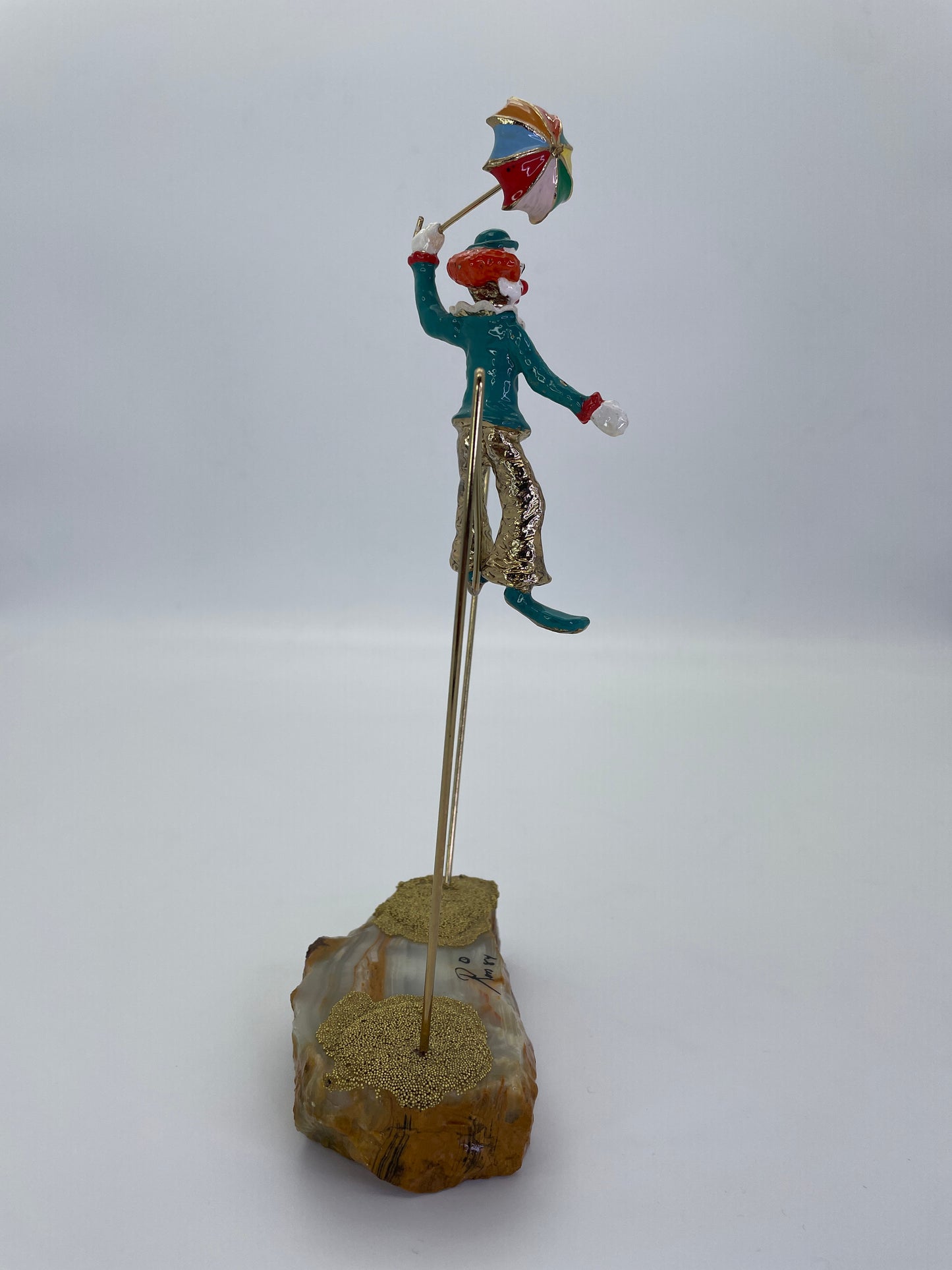 Left side profile of a Ron Lee high wire circus clown sculpture.