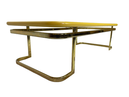 Side perspective view of 1970s Lane coffee table with brass-tone metal frame and yellow lacquer finish.