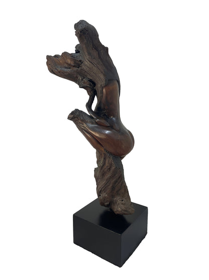 Side view of monumental figurative carved wood sculpture by Sig de Tonancour with organic modern sculptural form and black pedestal.