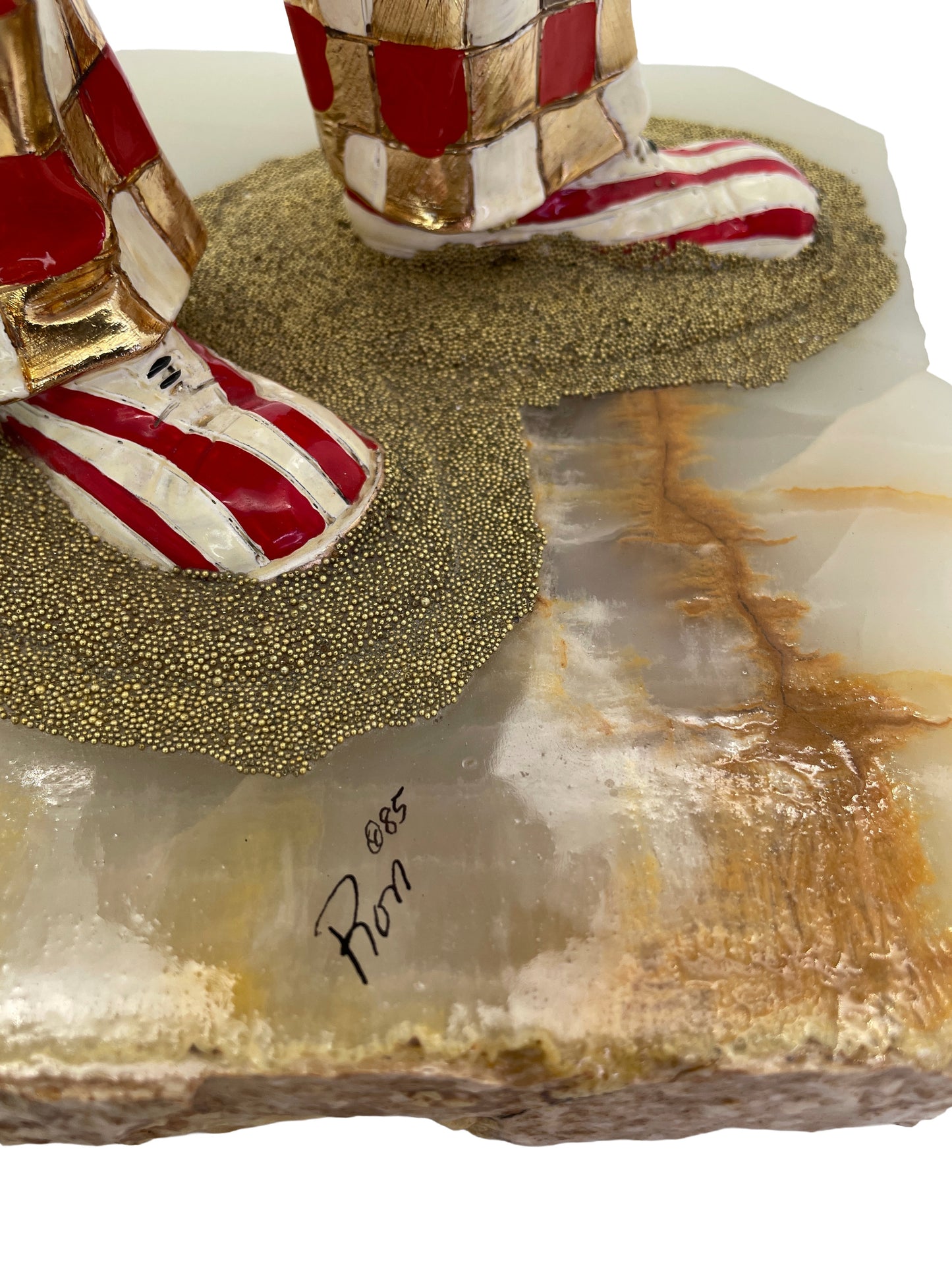 Close-up of the artist’s signature “Ron ’85” on the natural onyx base of a vintage Ron Lee sculpture.