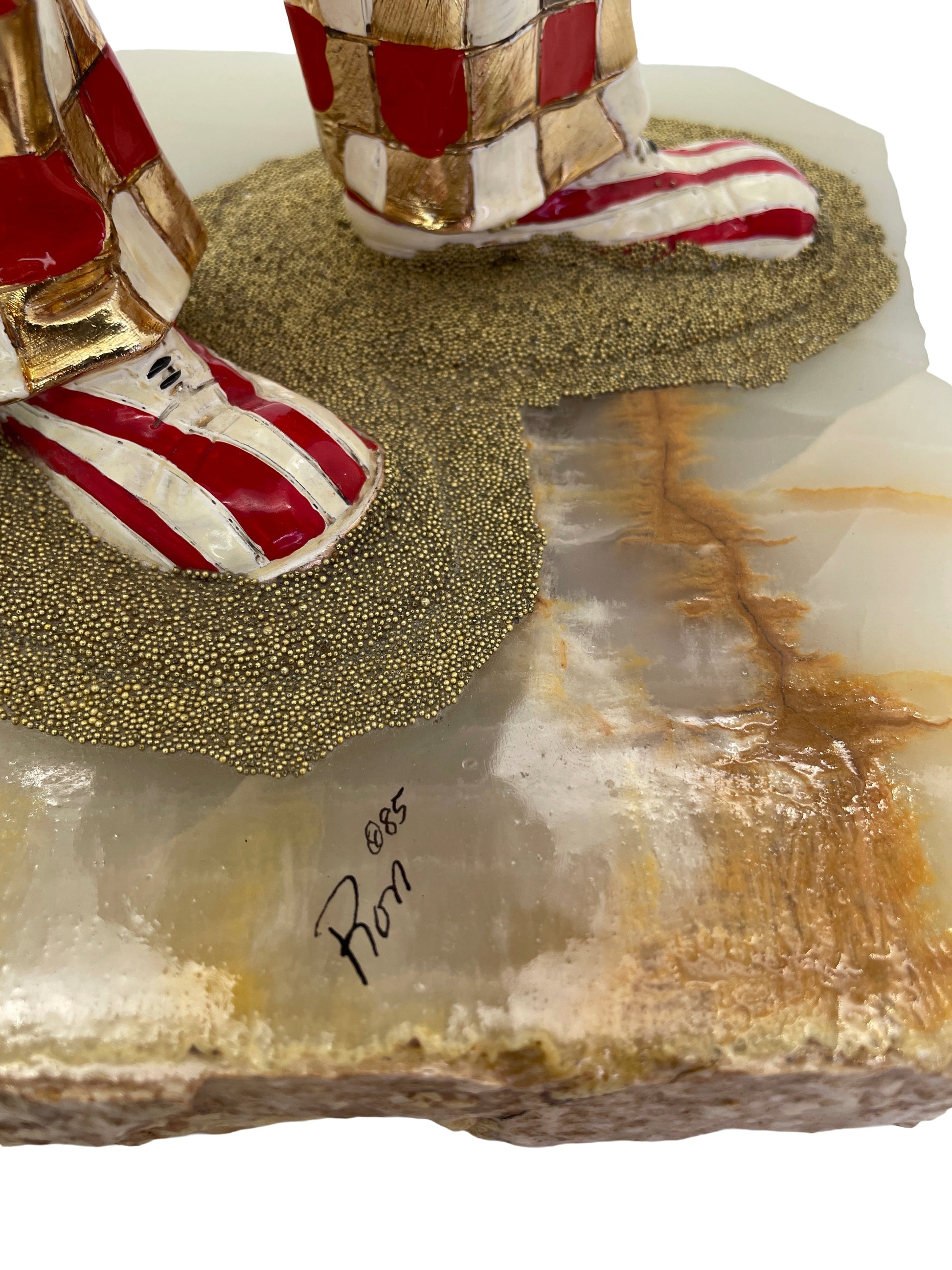 Close-up of the artist’s signature “Ron ’85” on the natural onyx base of a vintage Ron Lee sculpture.