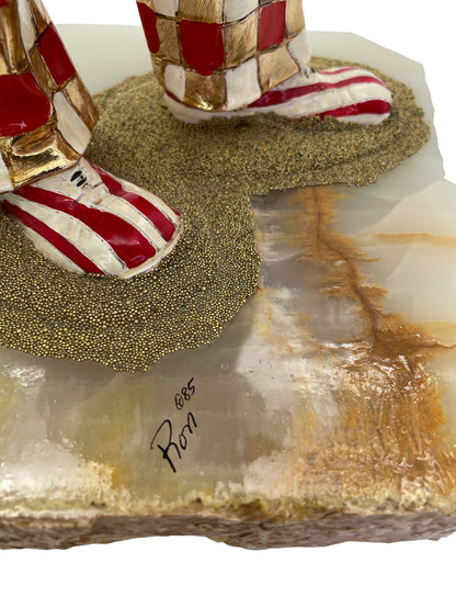 Close-up of the artist’s signature “Ron ’85” on the natural onyx base of a vintage Ron Lee sculpture.