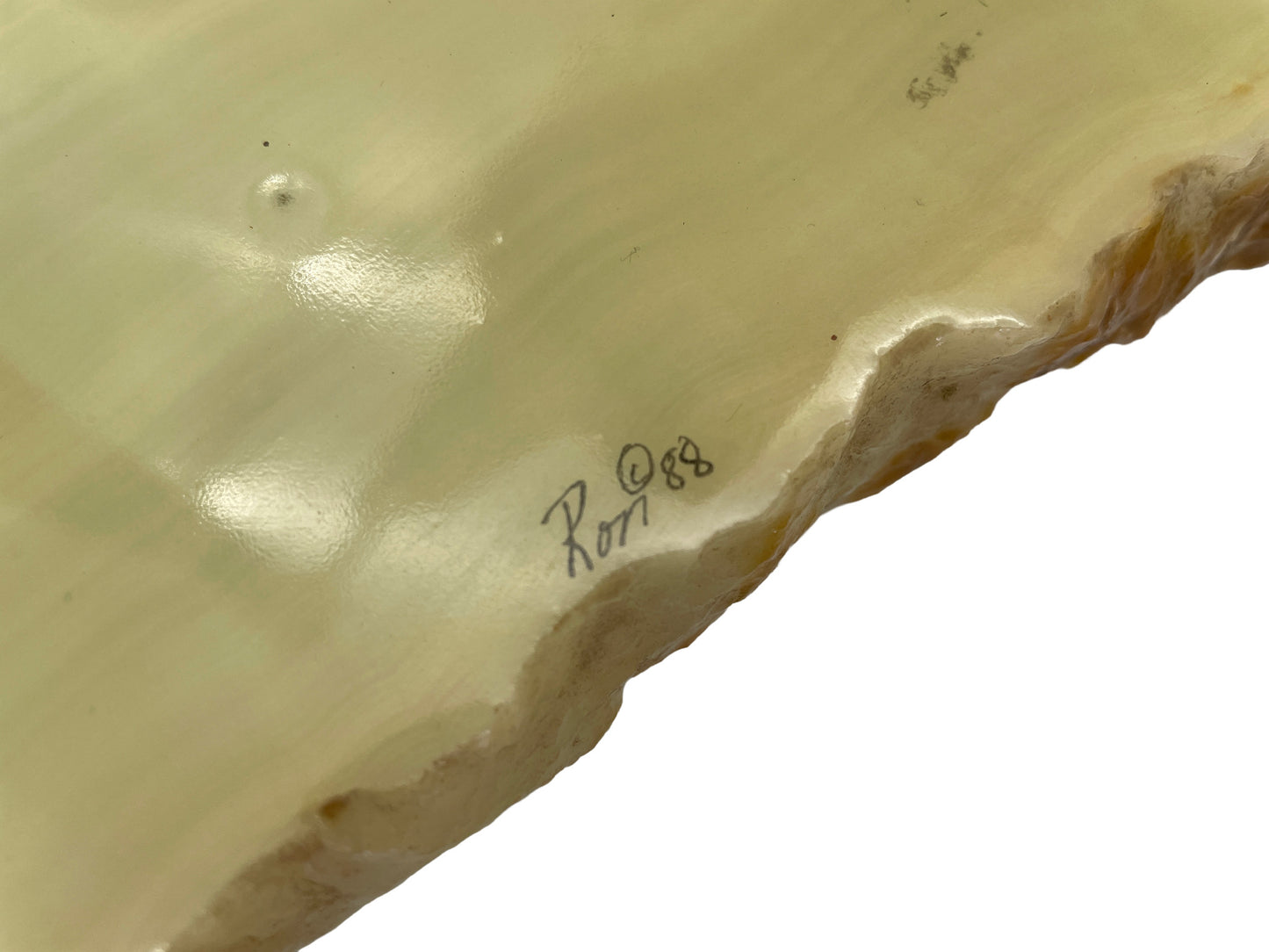 Close-up of the original Ron Lee signature and 1988 date on the natural onyx base, confirming the sculpture’s authenticity.