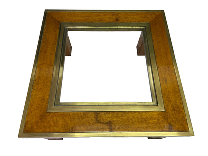 Overhead view of a square olive ash burl coffee table with brass frame and recessed glass insert.