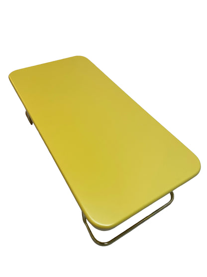 Top angle view of vintage Lane coffee table with rounded lemon yellow lacquer top and brass-tone base.