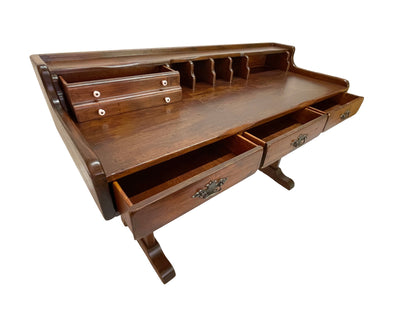 Detail view of storage drawers and organizer compartments on an antique Victorian secretary writing desk.
