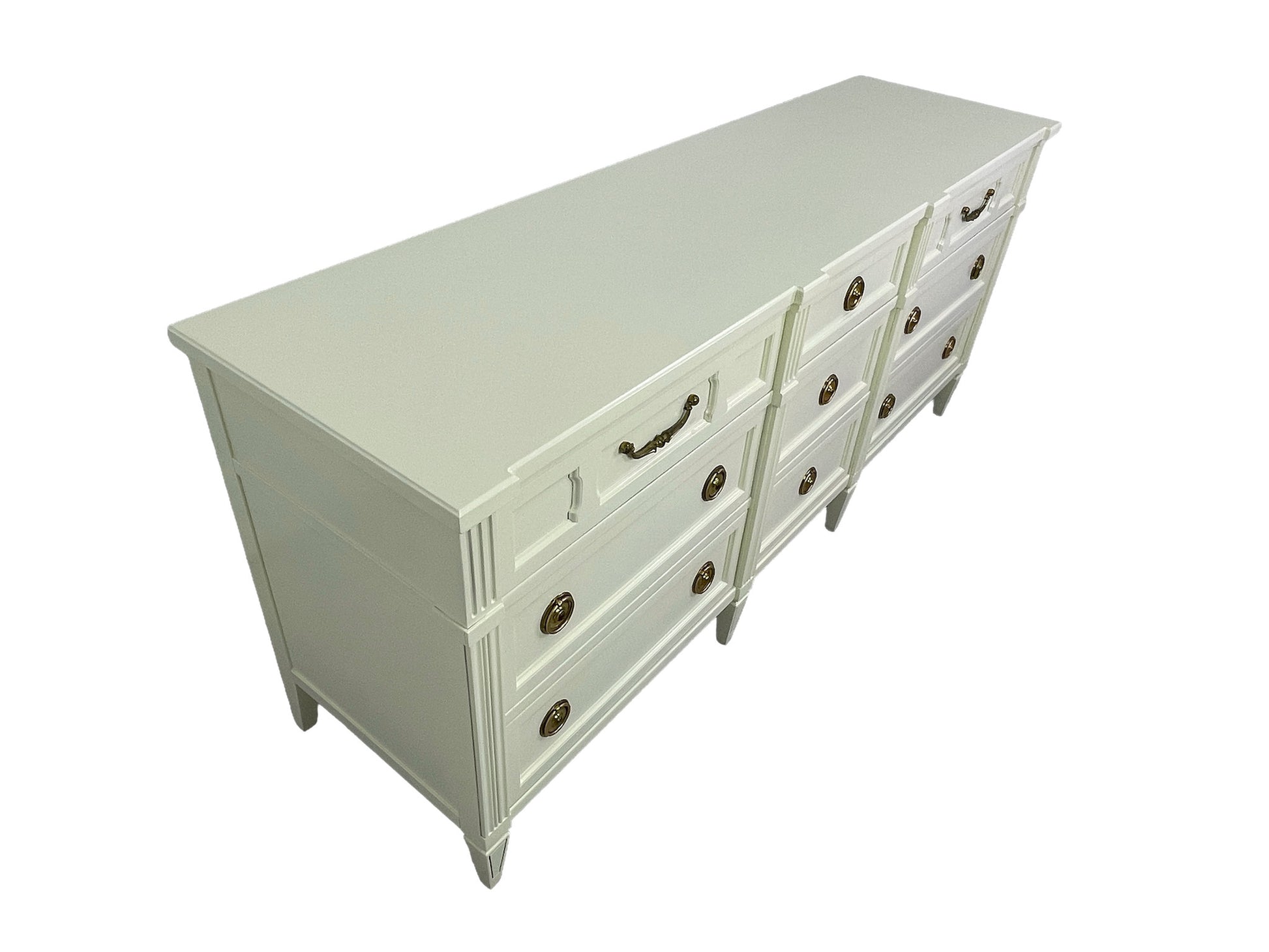 American of Martinsville lacquered dresser in off-white with brass hardware, angled view left side
