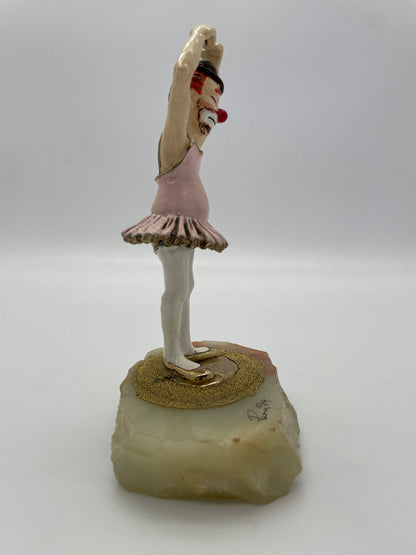 Right side profile of a signed Ron Lee ballet clown sculpture with pink tutu and natural onyx base.