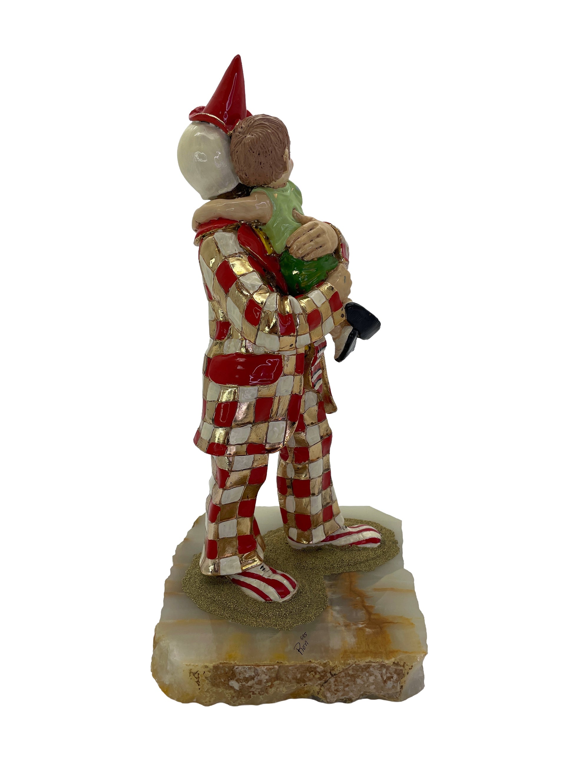 Rear view of a signed Ron Lee figural sculpture depicting a child embracing a clown on a natural onyx base, dated 1985.