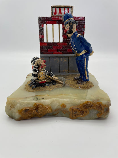 Front view of a vintage Ron Lee Great Escape clown sculpture depicting a police clown confronting a prisoner clown escaping from jail.