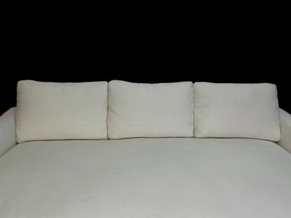 Detail of white cotton upholstery and oversized back cushions on custom contemporary lounge daybed.
