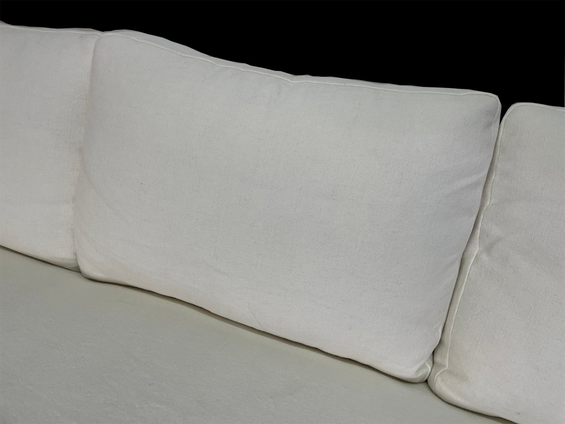 Detail view of oversized white linen back cushions on custom contemporary lounge daybed.
