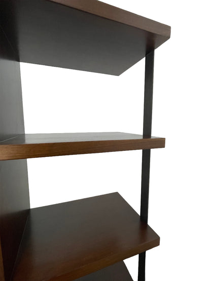 Close-up of integrated metal support reinforcing the open walnut shelving design