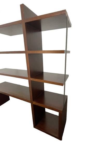 Angled view of detail of intersecting walnut shelves highlighting architectural structure and craftsmanship