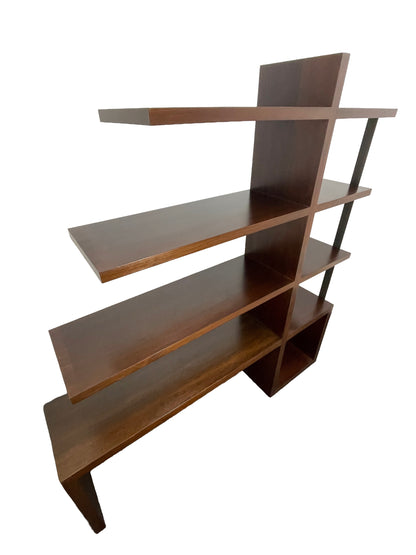 Angled view of William Emmerson modern walnut bookcase with open shelving and sculptural form top left side