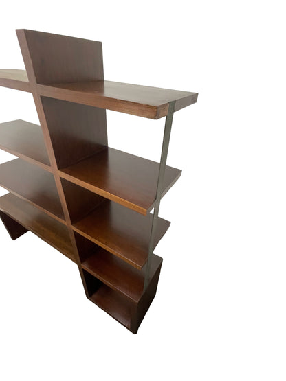 Angled view of William Emmerson modern walnut bookcase with open shelving and sculptural form top right side